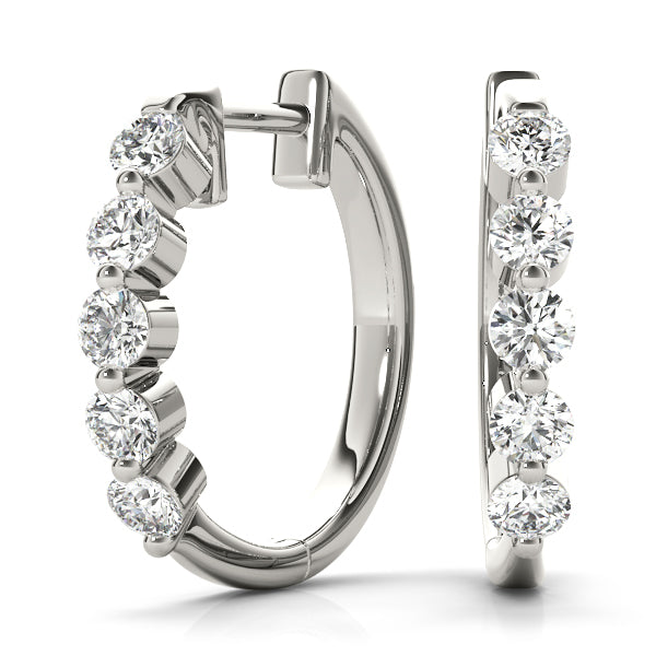 1CT diamond bezel-set huggie hoop earrings in white gold with round brilliant-cut diamonds and a secure hinged closure.