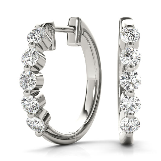 1CT diamond bezel-set huggie hoop earrings in white gold with round brilliant-cut diamonds and a secure hinged closure.